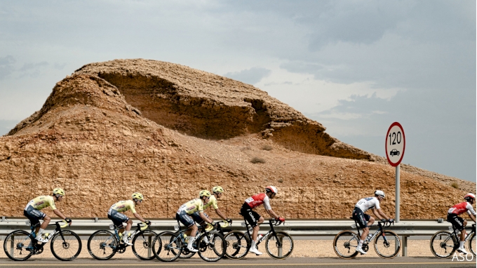 2024 Tour of Oman stage 3 riders pass rugged landscape