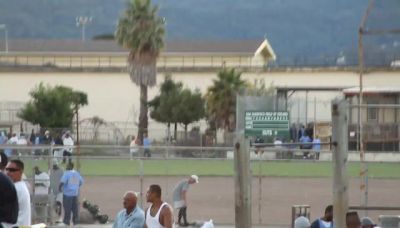 Inmates exercising and moving on the yard at San Quentin State Prison
