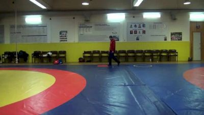 Kurbanaliev and Romanov warming up alone before they wrestle each other